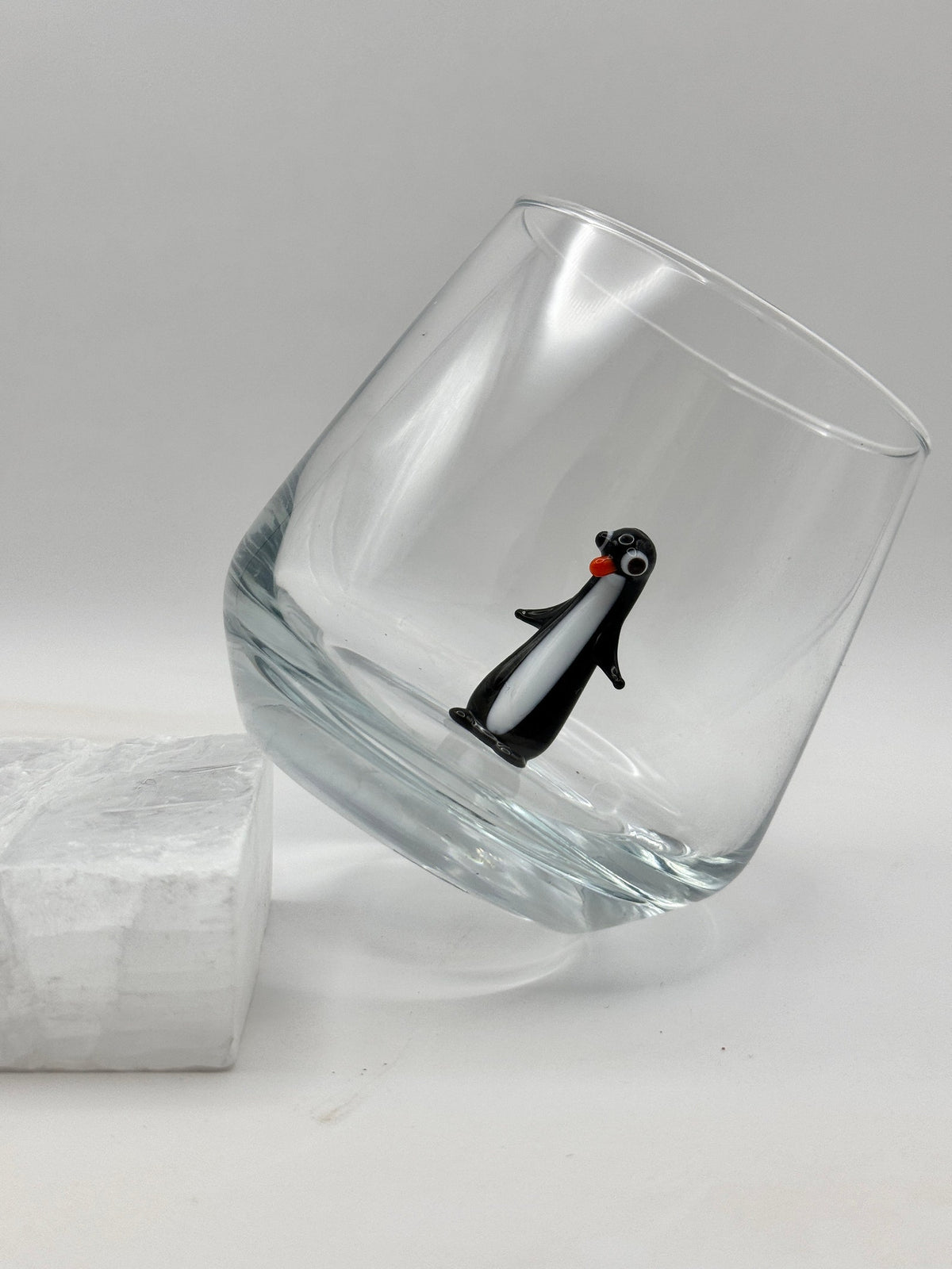 Penguin figurine stemless tumbler in a styled drinkware setting