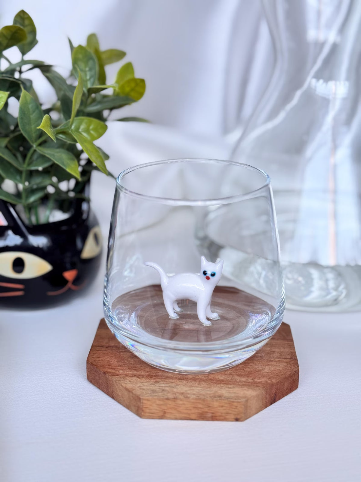 Art glass cat figurine detail and clear cup profile