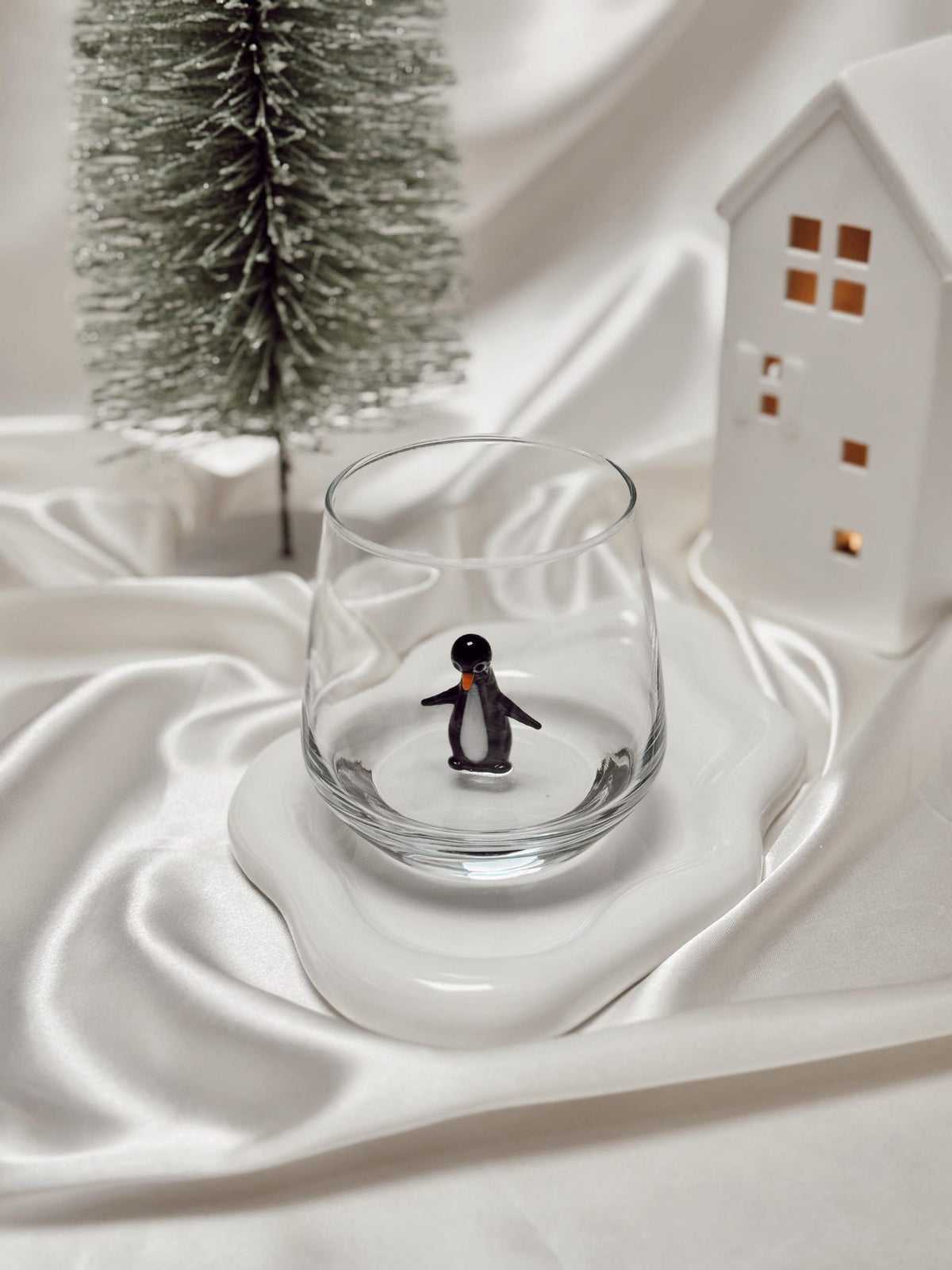 Clear stemless glass with a hand-formed penguin figurine inside