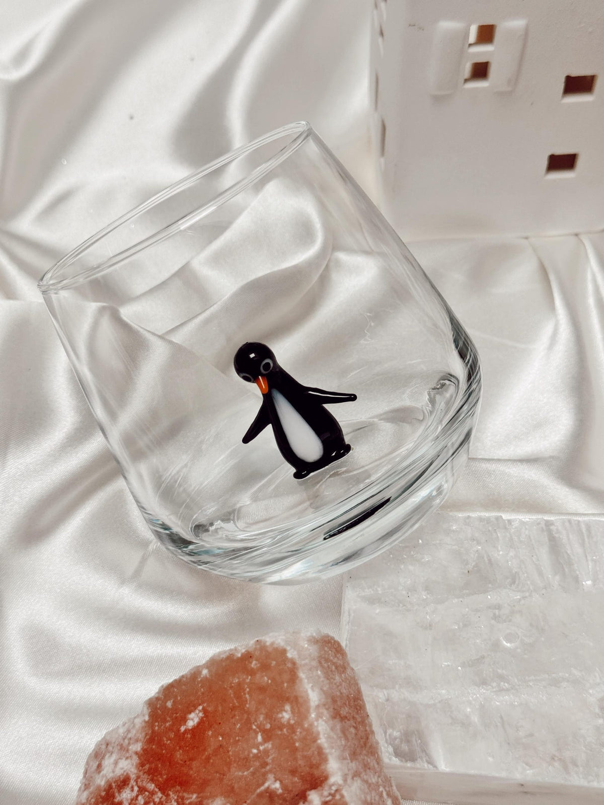 Close detail of the three-dimensional penguin inside the glass