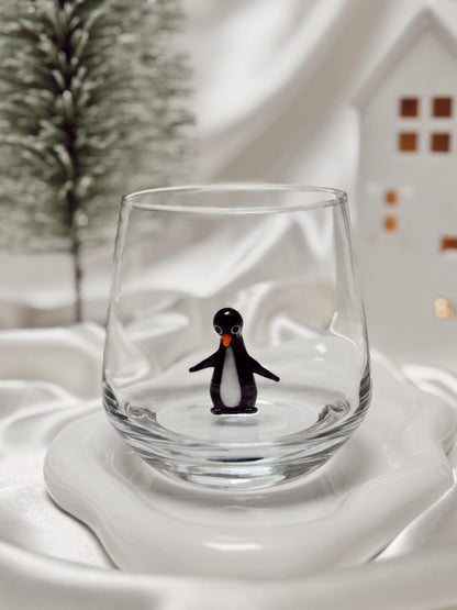 Whimsical penguin art glass displayed as a winter gift