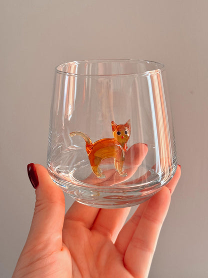 Clear stemless cat glass cup in a styled drinkware setting