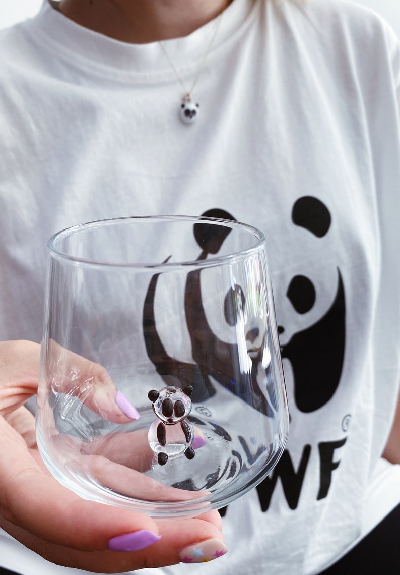 Hand-held panda figurine glass showing its clear stemless shape