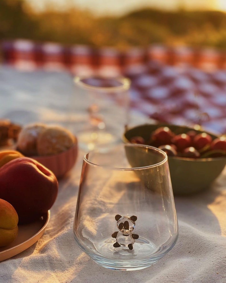 Panda tumbler styled with cherries and fruit on a tablecloth