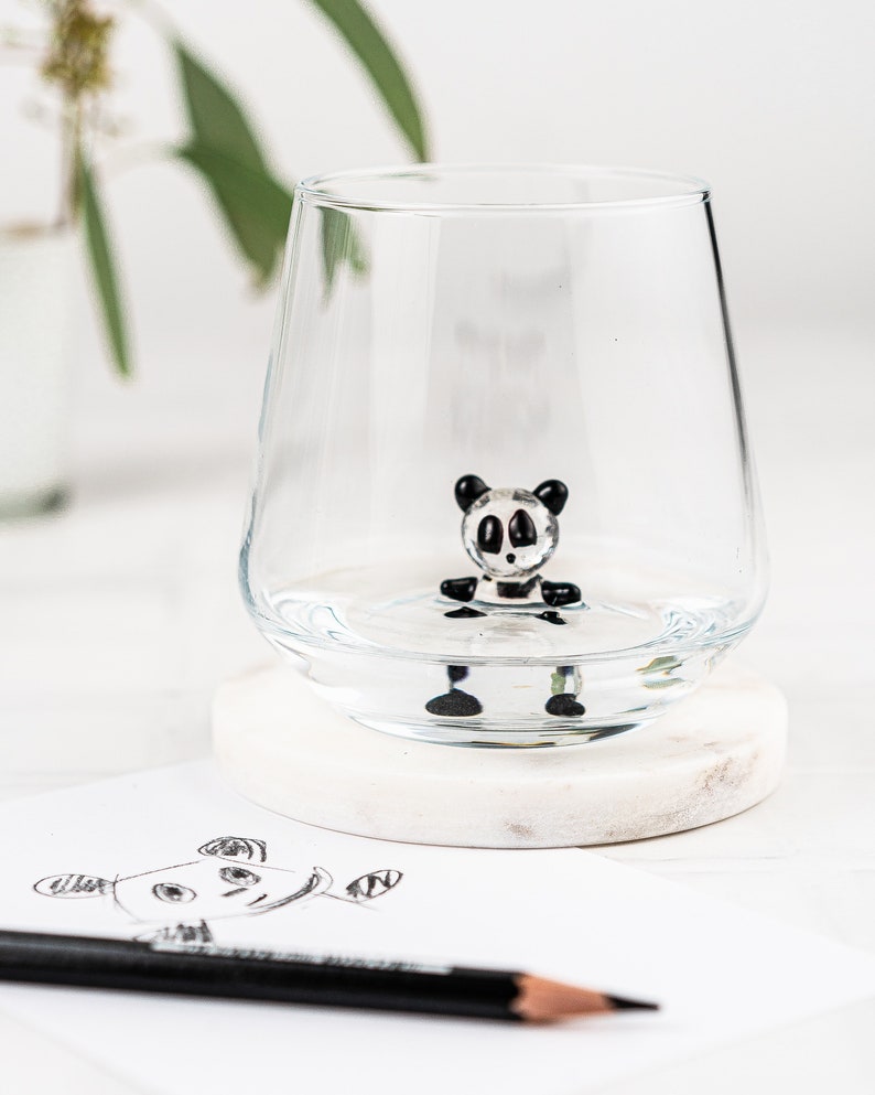 Panda animal glass styled with pencils and a panda drawing