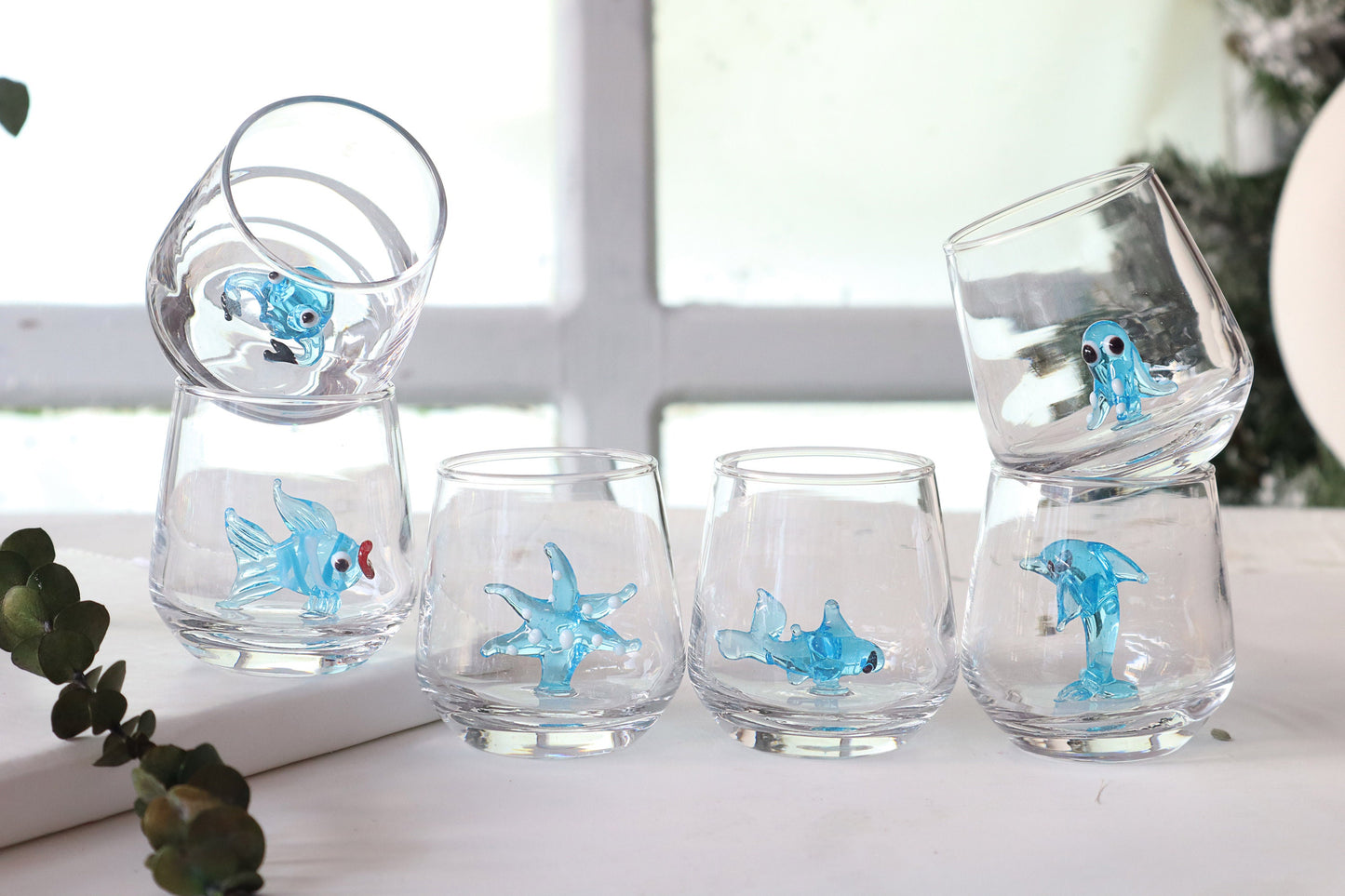 Blue octopus figurine inside a clear ocean themed shot glass