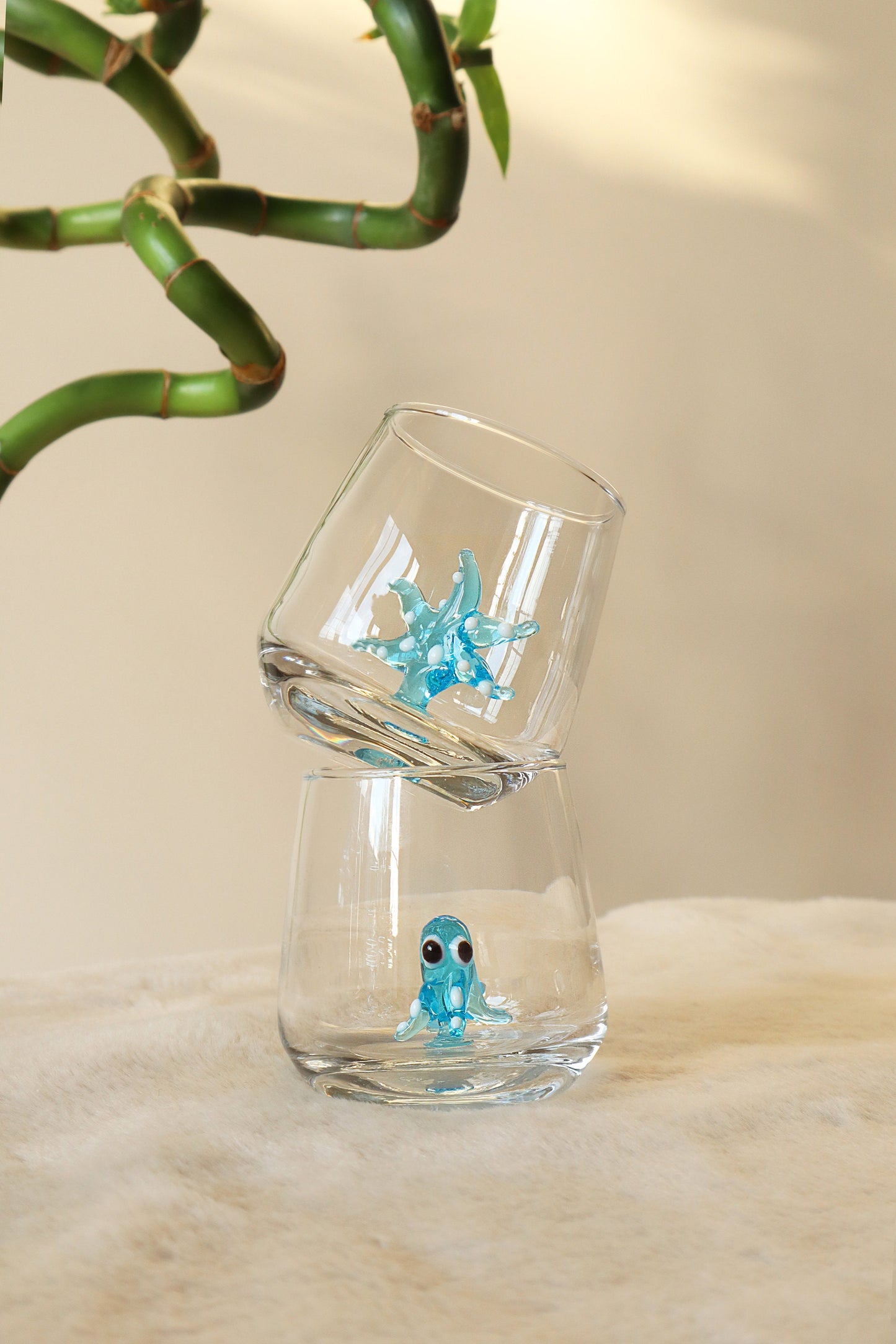 Blue shark figurine inside a clear shot glass
