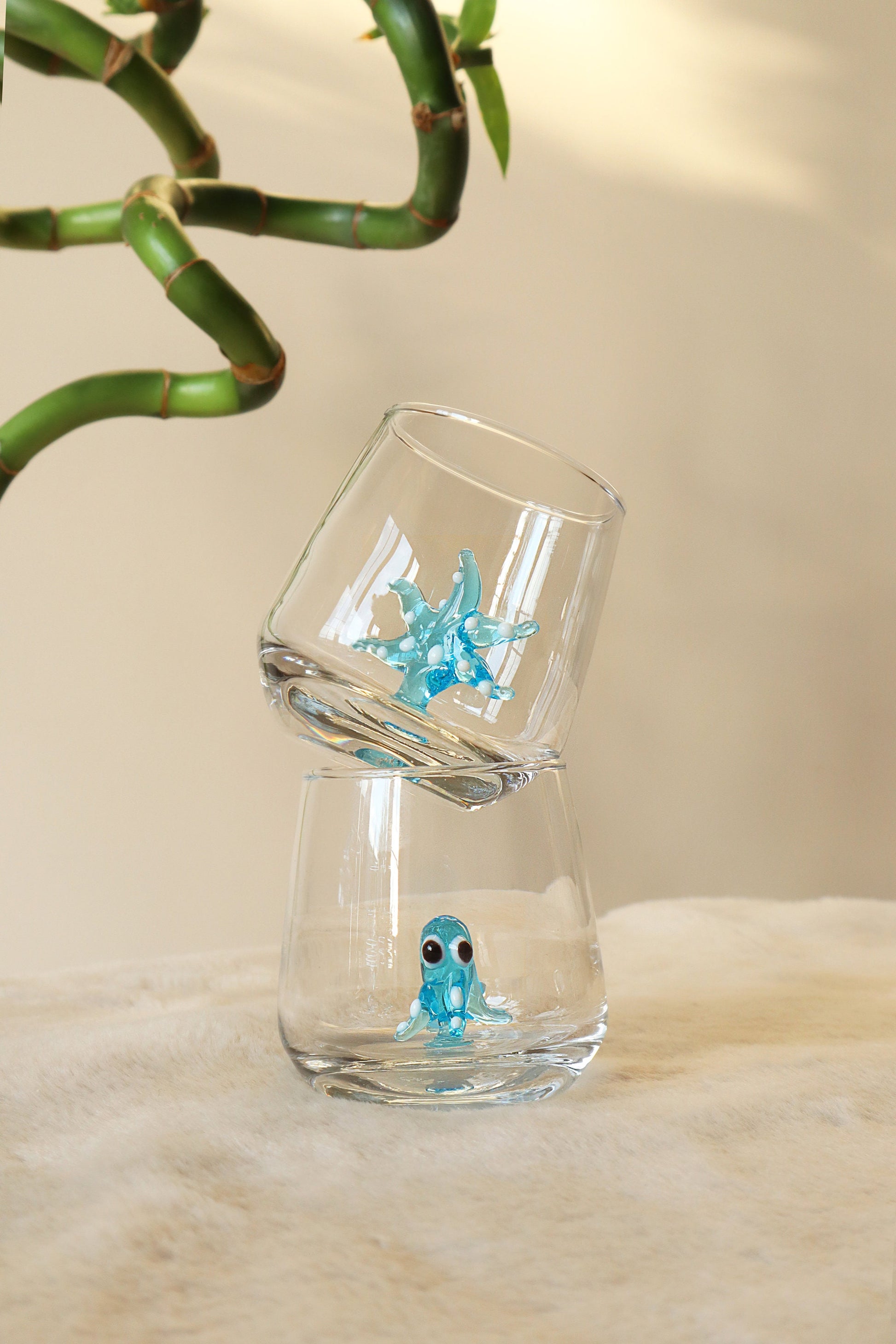 Blue shark figurine inside a clear shot glass
