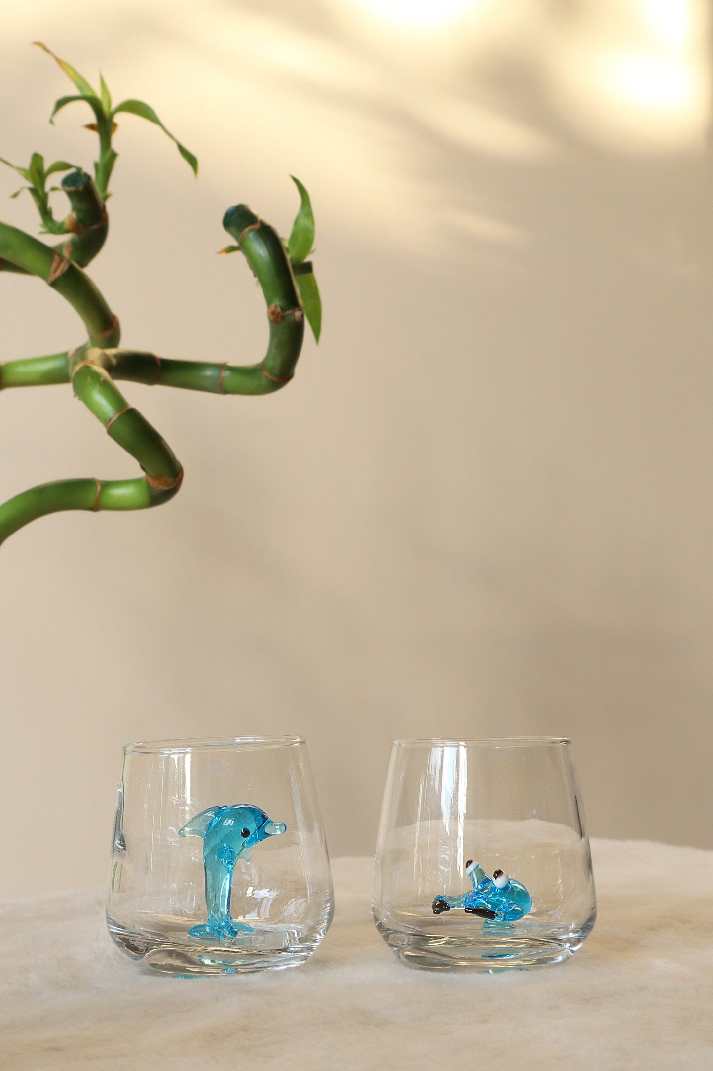 Blue dolphin figurine inside a nautical shot glass