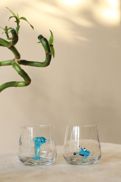 Blue dolphin figurine inside a nautical shot glass