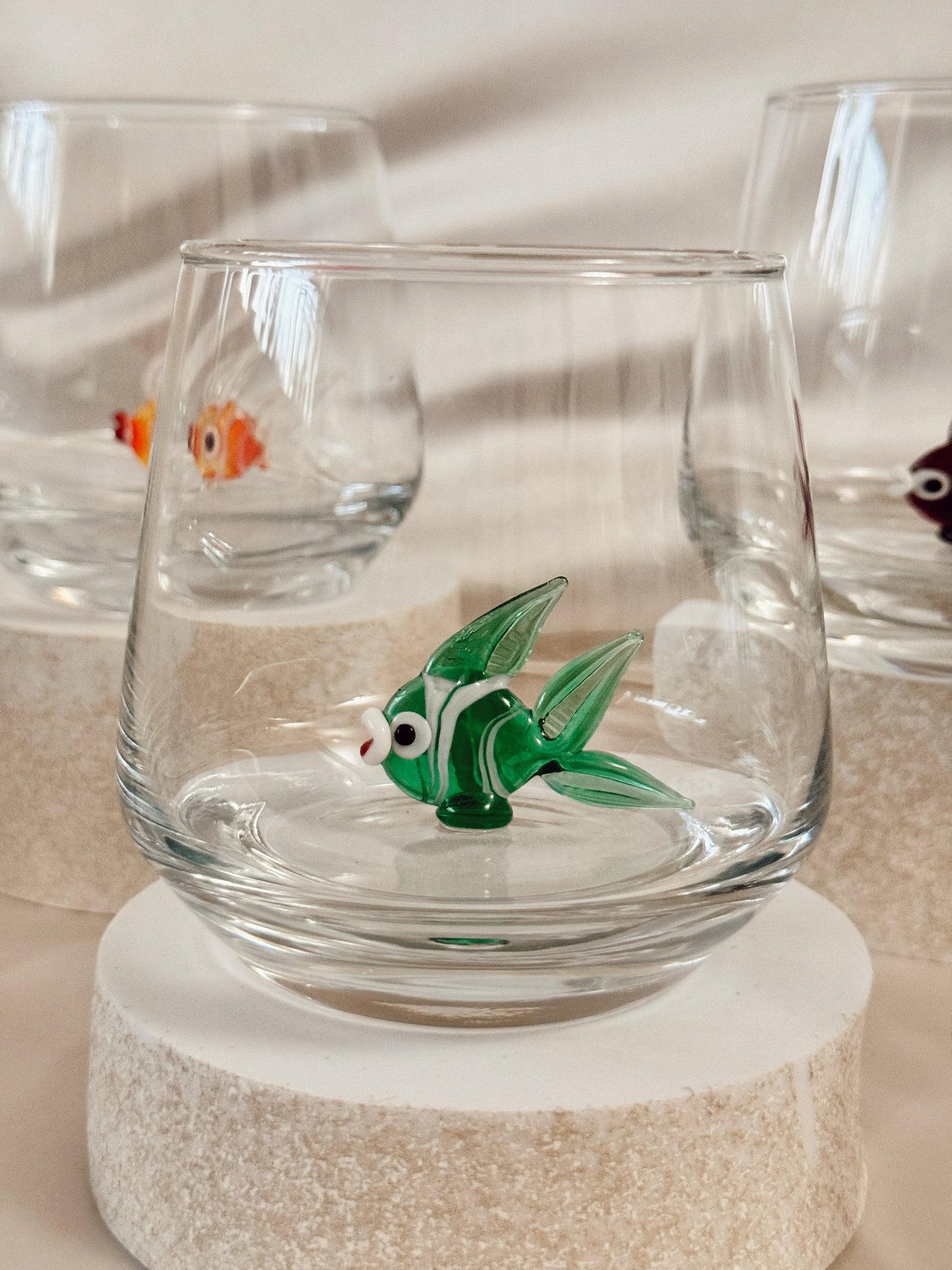 Yellow fish figurine inside a clear nautical drinking glass