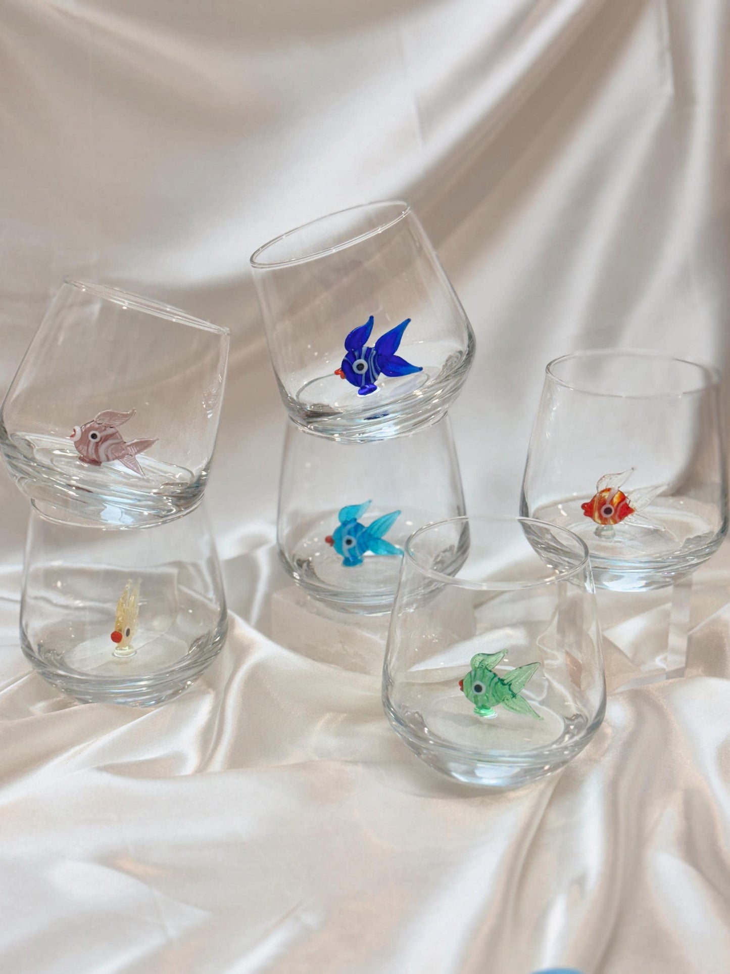 Colorful fish figurine stemless wine glasses displayed together