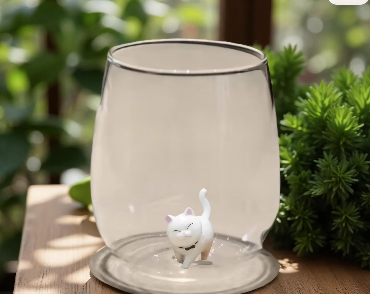 Clear cat figurine wine glass shown from the side