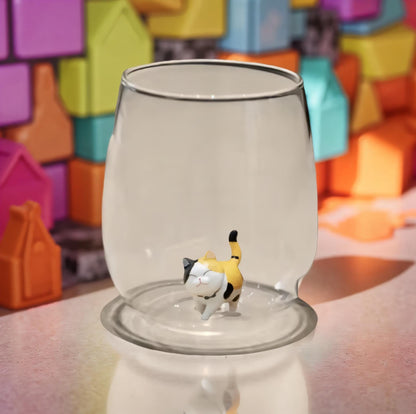 Close view of the artisan cat figurine inside the glass