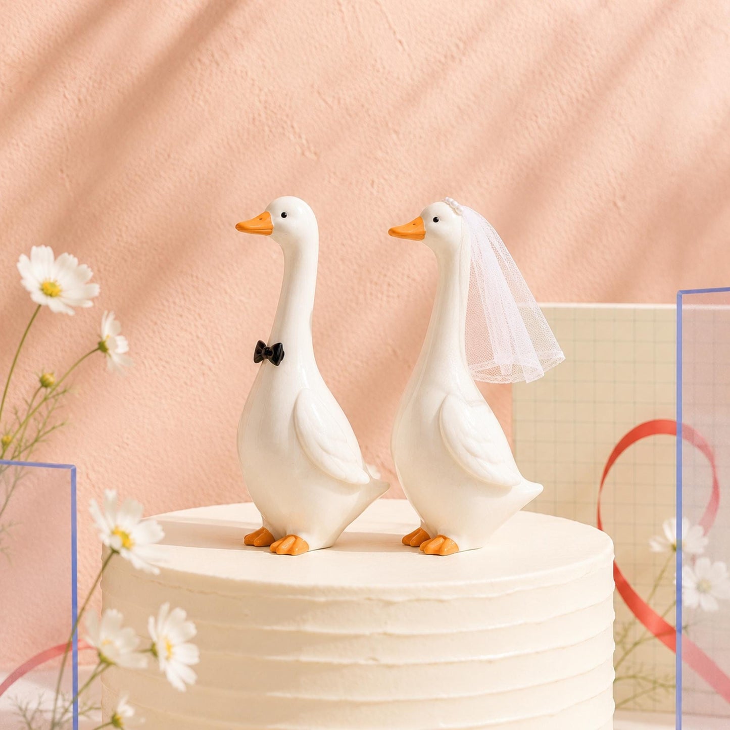 Goose bride and groom figurines displayed on a wedding cake