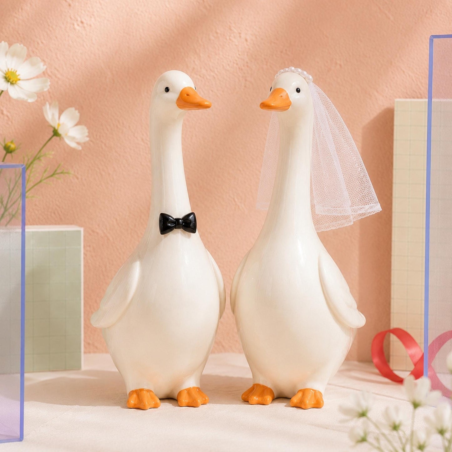 Close view of ivory ceramic goose wedding figurine couple