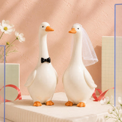 Ivory white ceramic goose bride and groom wedding cake topper pair