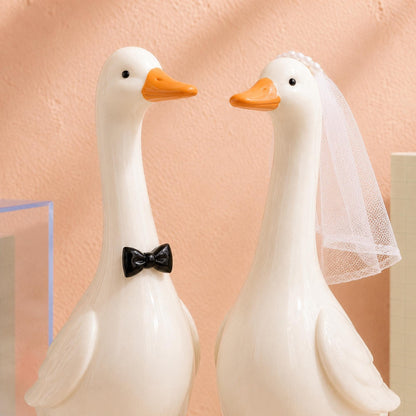 Ceramic goose groom with black bow tie and bride with white veil