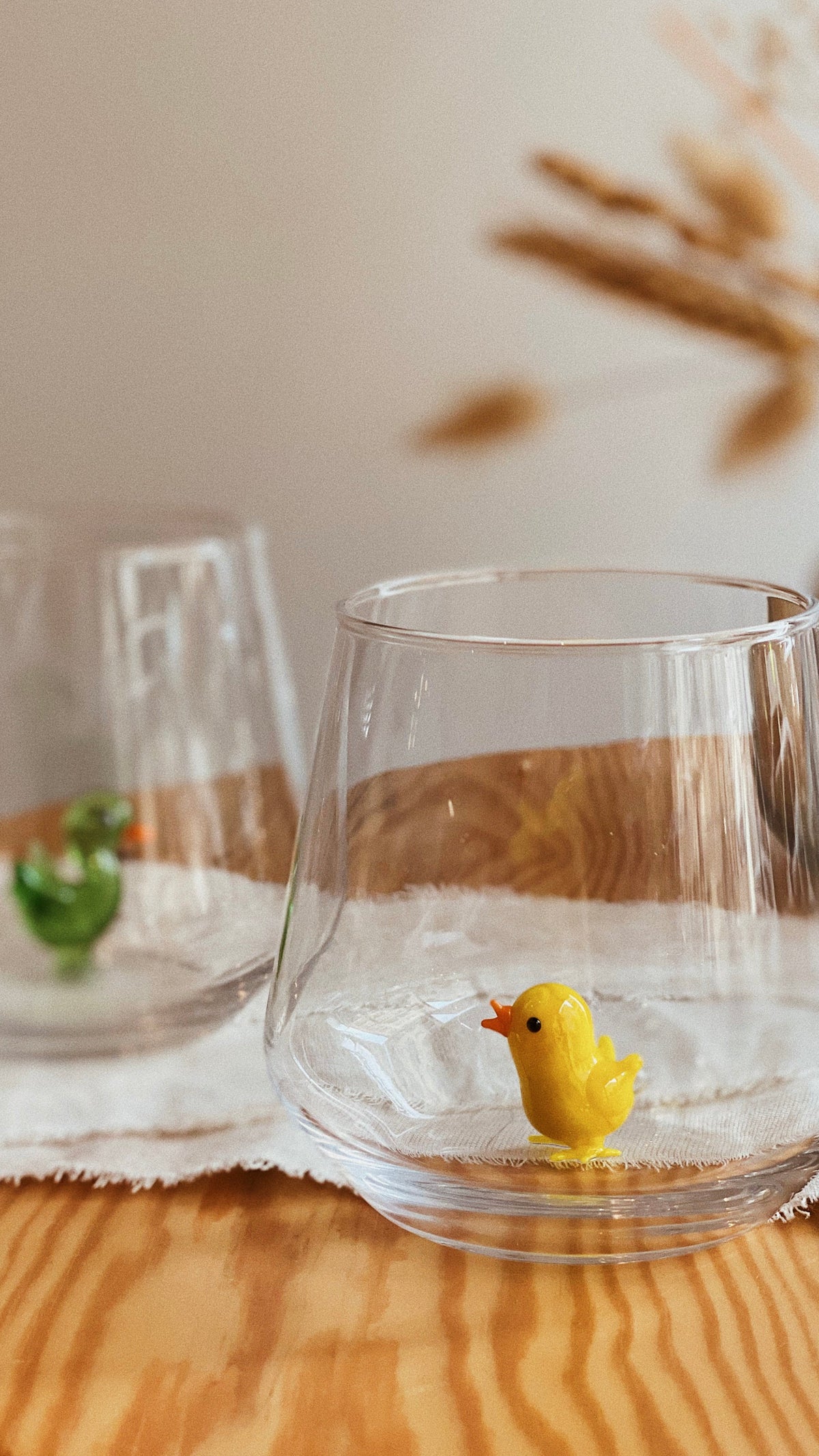 Close view of the miniature glass chick inside the drinking tumbler