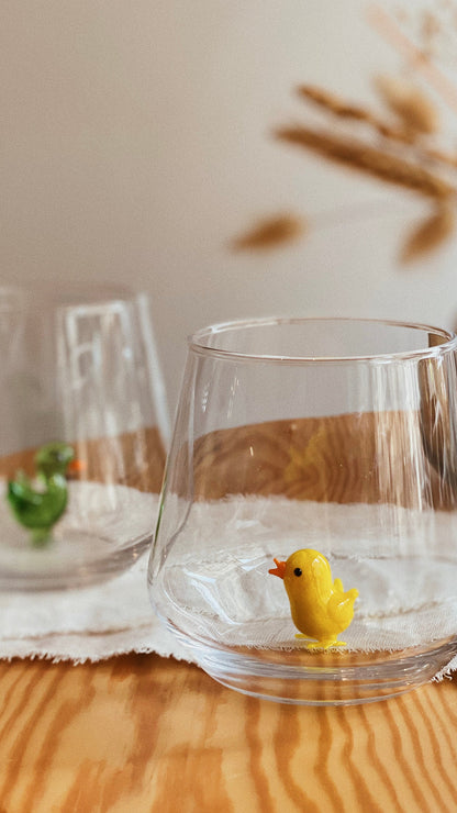 Close view of the miniature glass chick inside the drinking tumbler
