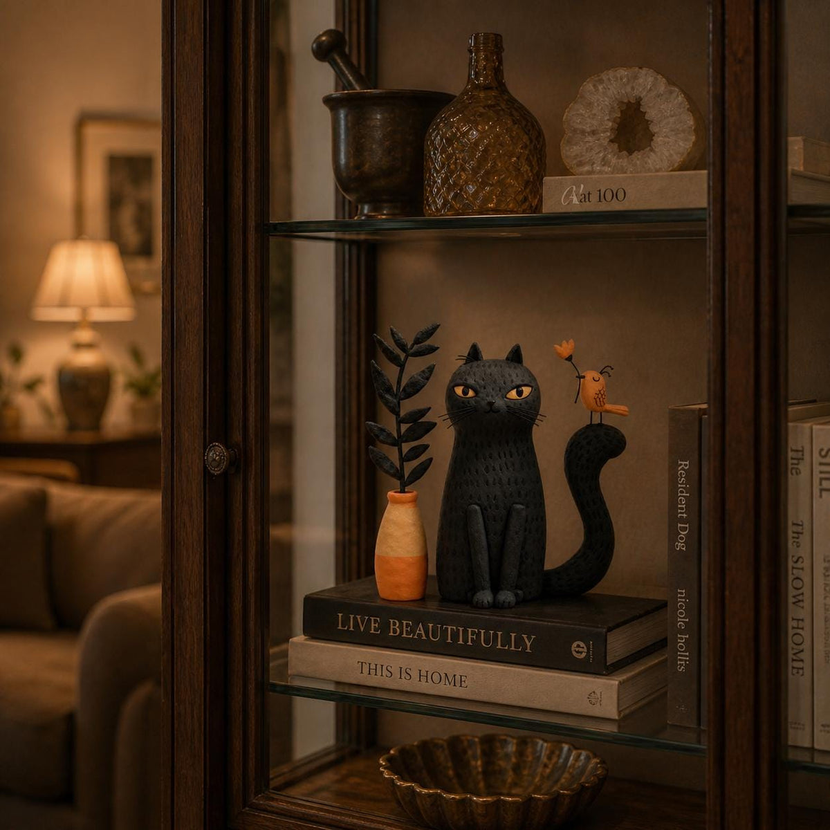 Black cat with orange bird figurine — image 4