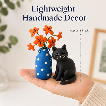 Handmade black cat with blue polka-dot vase and orange clay flowers