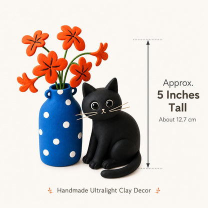 Handmade black cat with blue polka-dot vase and orange clay flowers